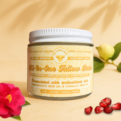 Jar of 'All-In-One Tallow Balm' with flowers and pomegranate seeds on a beige background