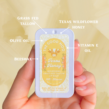 Lip balm labeled with ingredients held in a hand against a light background